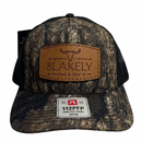 Camouflage BF&S Richardson hat with leather Blakely Feed & Seed patch on a white background
