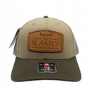 Tan BF&S Richardson 112 hat with leather patch and dark brim on a white background
